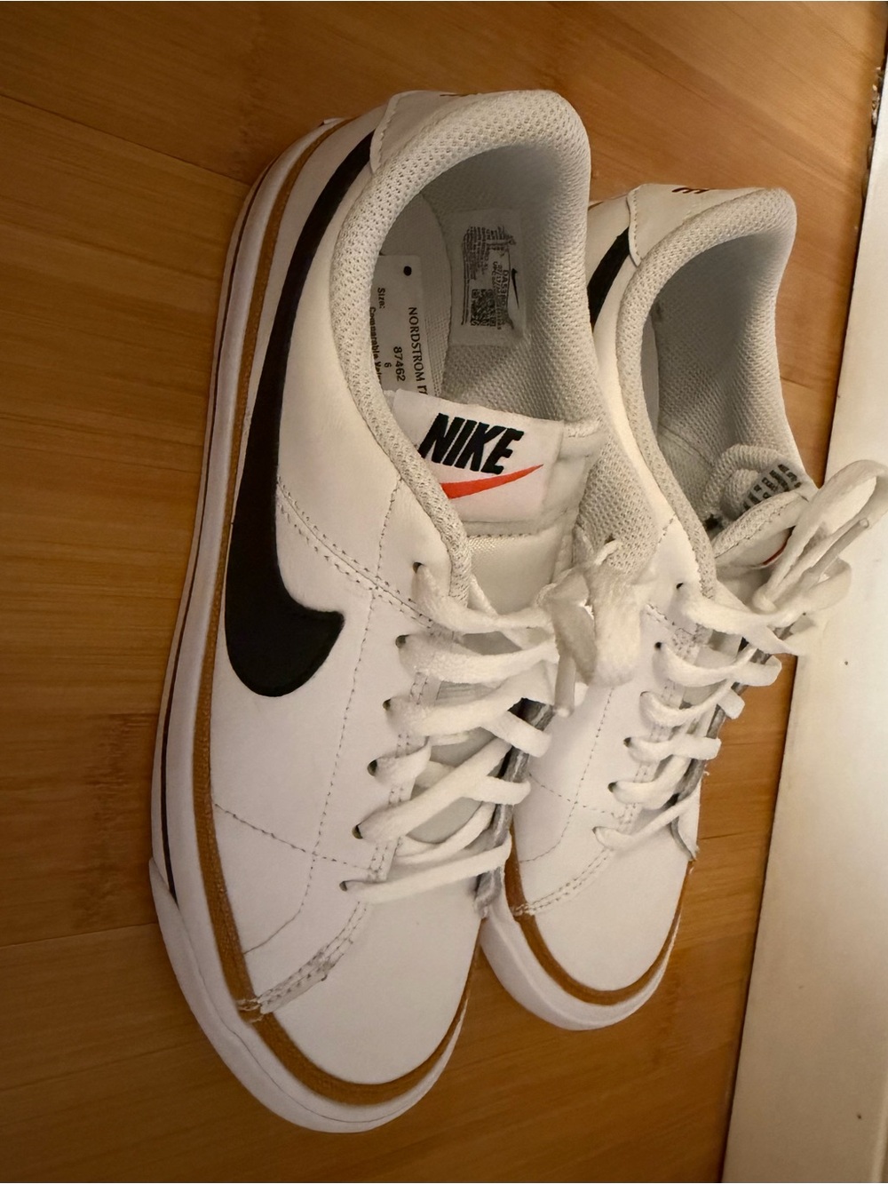 Nike White Leather Sneakers with Black Swoosh and Brown Trim